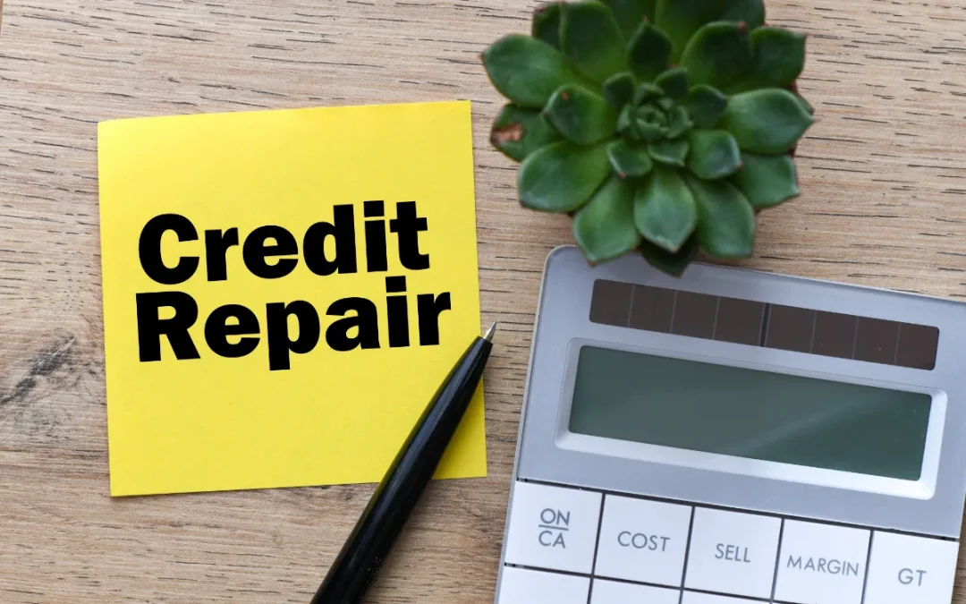 A "Credit Repair" sticky note, calculator, pen, and succulent on a desk